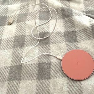 An iPhone any size phone charger in pink with wire